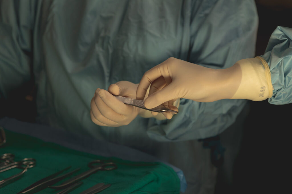 Surgeons' Gloved Hands Passing Surgery Tools Back and Forth