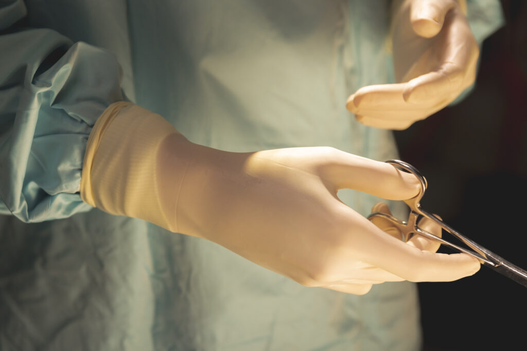 A Gloved Hand Holding a Surgical Tool